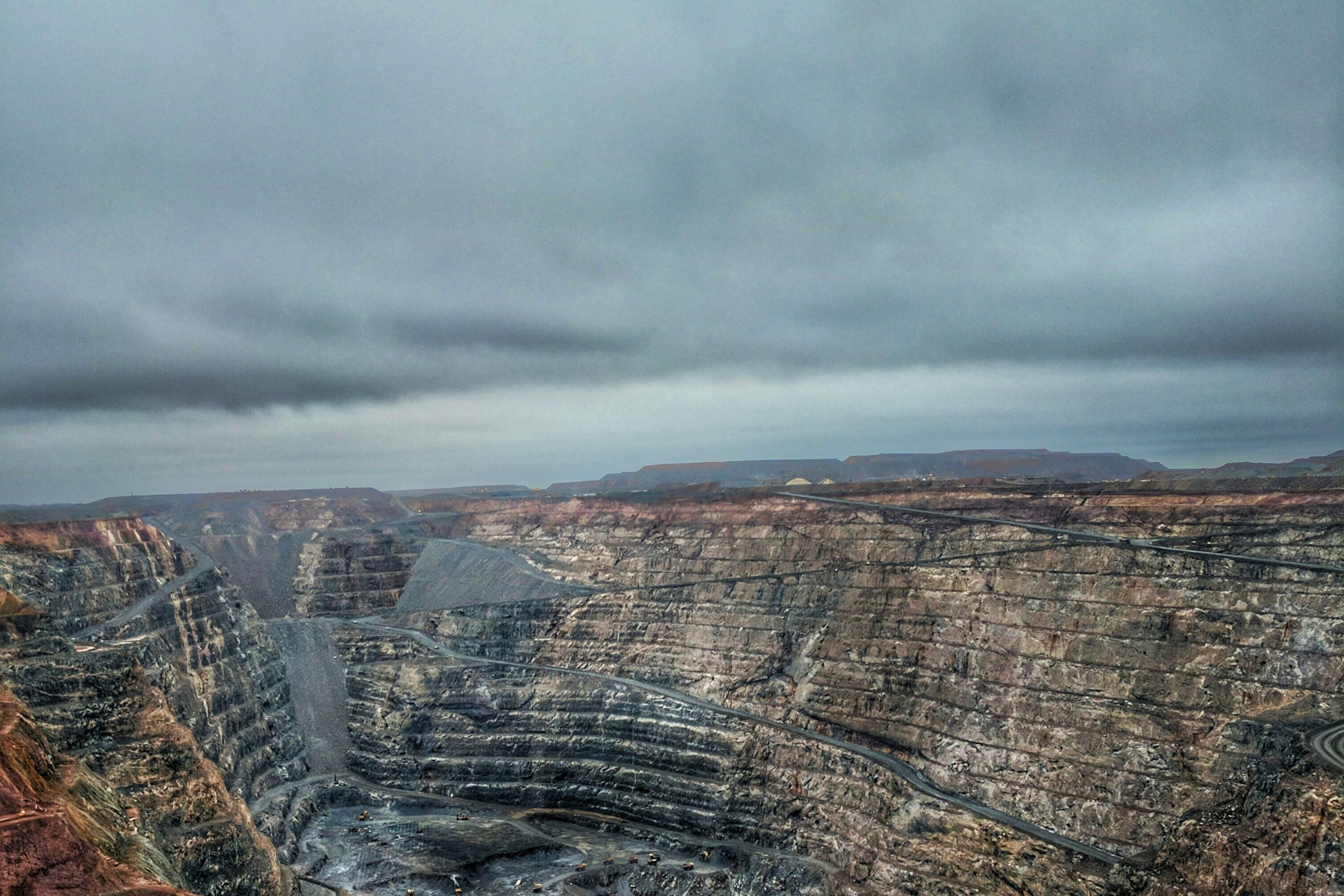 A large open-pit mining operation at golden hour
